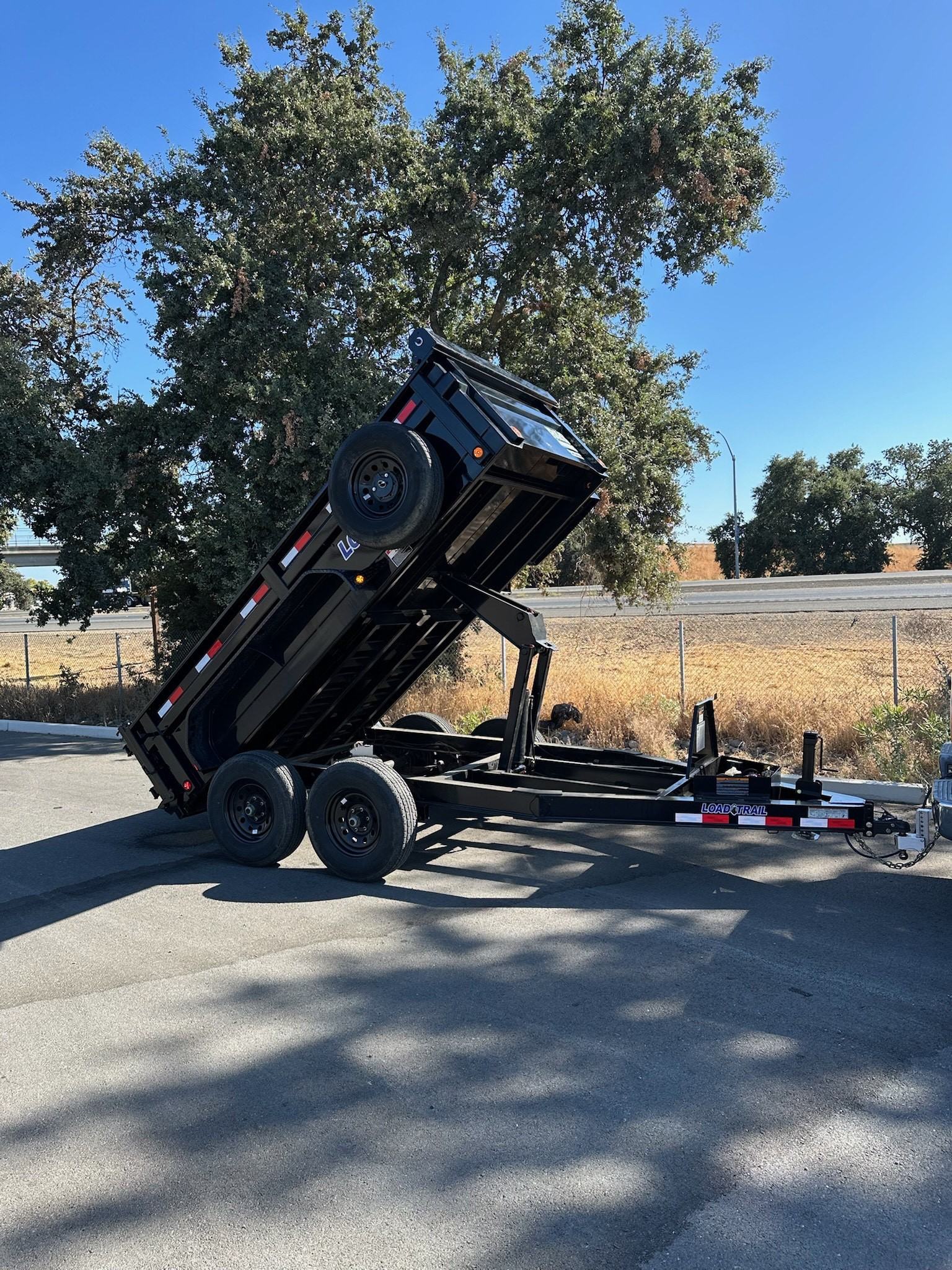 R&S Rentals 12ft dump trailer tilted and dumping