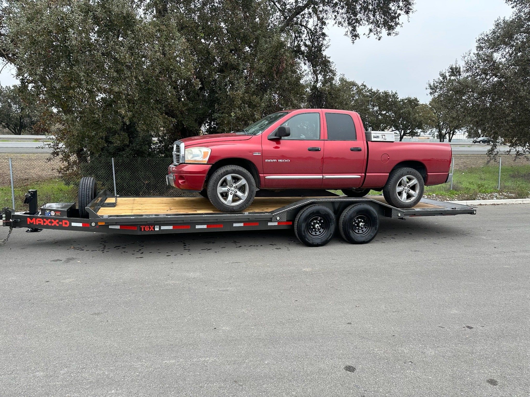 24ft tilt trailer hauling a truck for rent in Woodland, CA